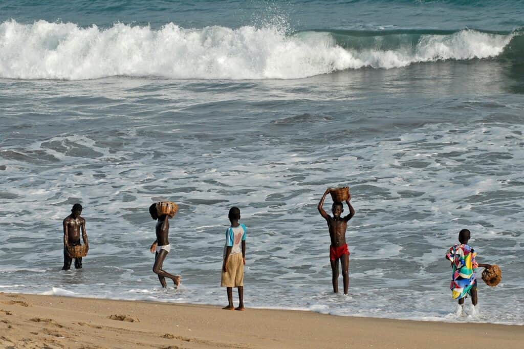 Ghana children playing in the sea, in the best countries to visit in Africa