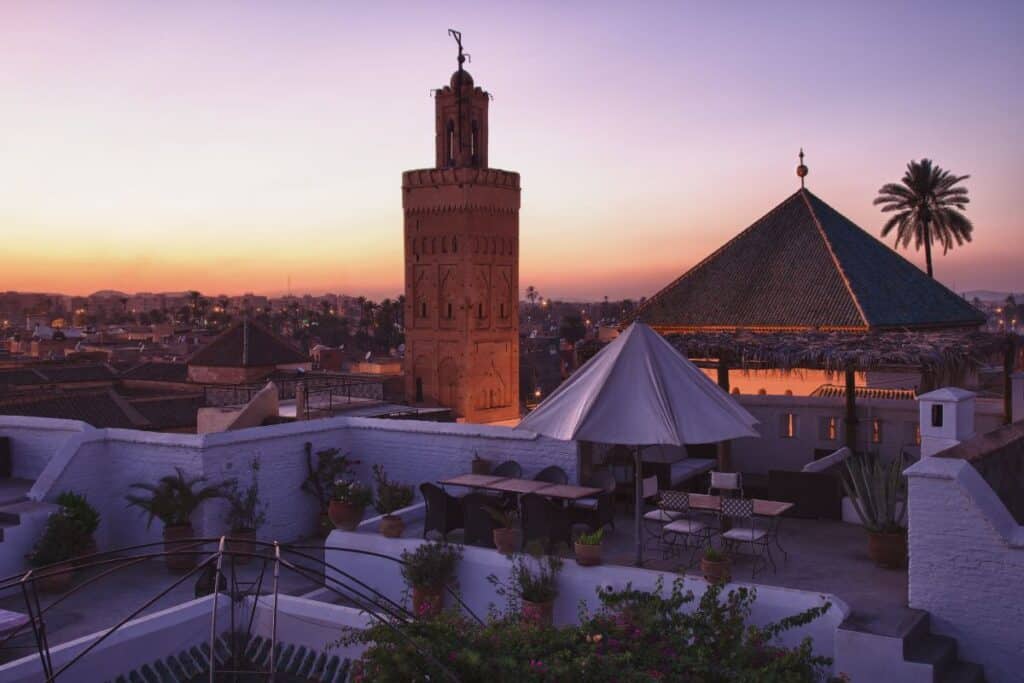 The Moroccan city of Marrakech at sunset from a rooftop cafe