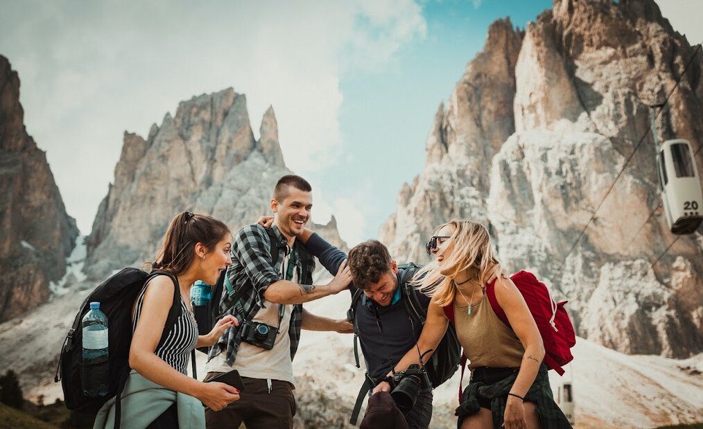 Friends laughing atop mountains
